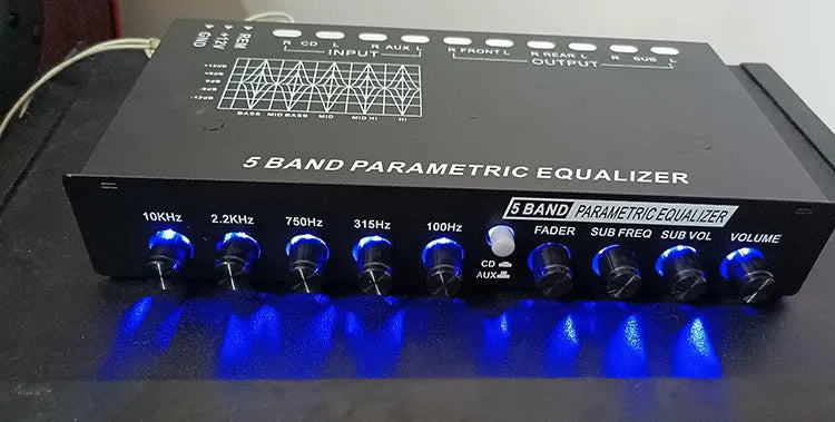 Black car audio EQ tuning amplifier with control panel for frequency and volume adjustment