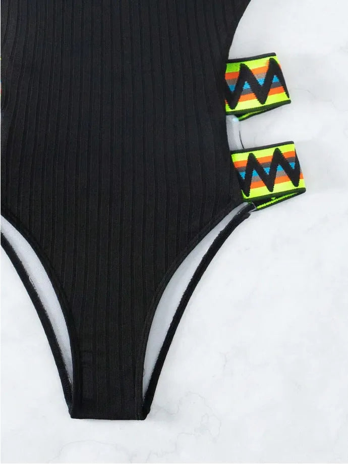 Black solid colour one-piece swimsuit on a mannequin, side view.