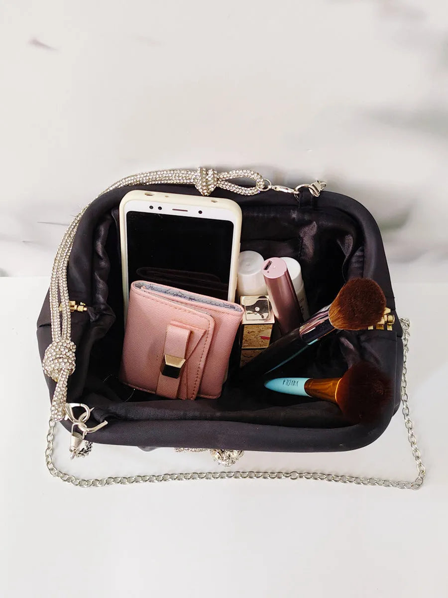 Women's soft polyester messenger bag with diamond quilting and chain strap in black colour