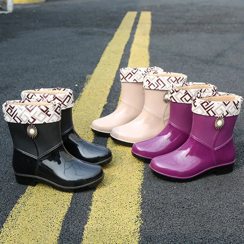 Women's purple PVC rain boot with non-slip sole and middle tube height.