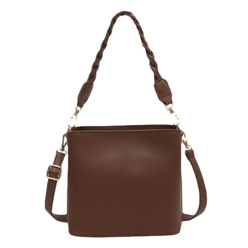 Retro woven crossbody bucket bag in khaki colour showing one-shoulder strap and textured PU material.
