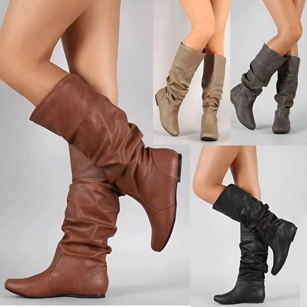 Women's flat heel slip-on boot in artificial PU with high cut and rubber sole.