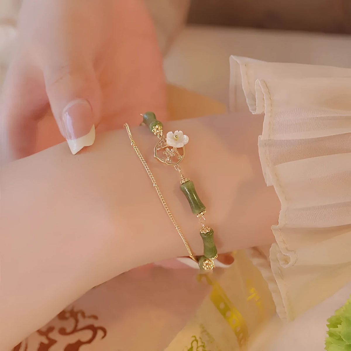 Natural green olivine stone bracelet with double layer Twin Bells of Ireland and Olive Branch design on an adjustable band.