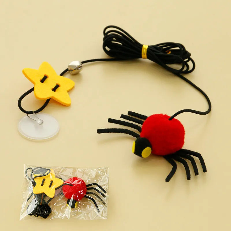 Red and yellow cat hanging door toy with elastic rope, feathers, a bell, and a spider attachment.
