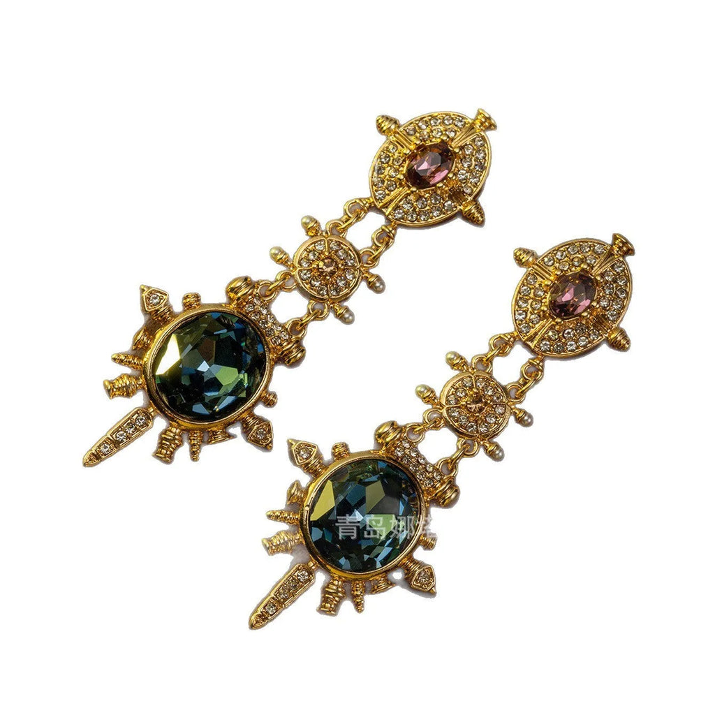 A pair of gold retro-style stud earrings with a geometry and round shape.