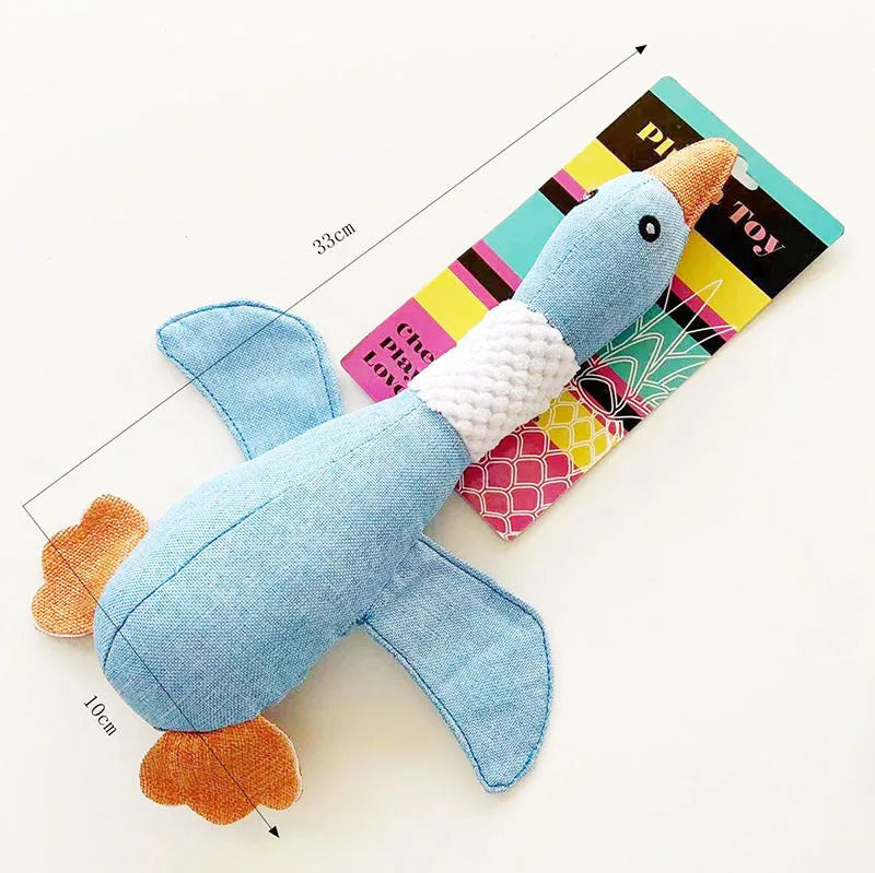 Blue durable duck-shaped plush dog toy with squeaker on a plain background