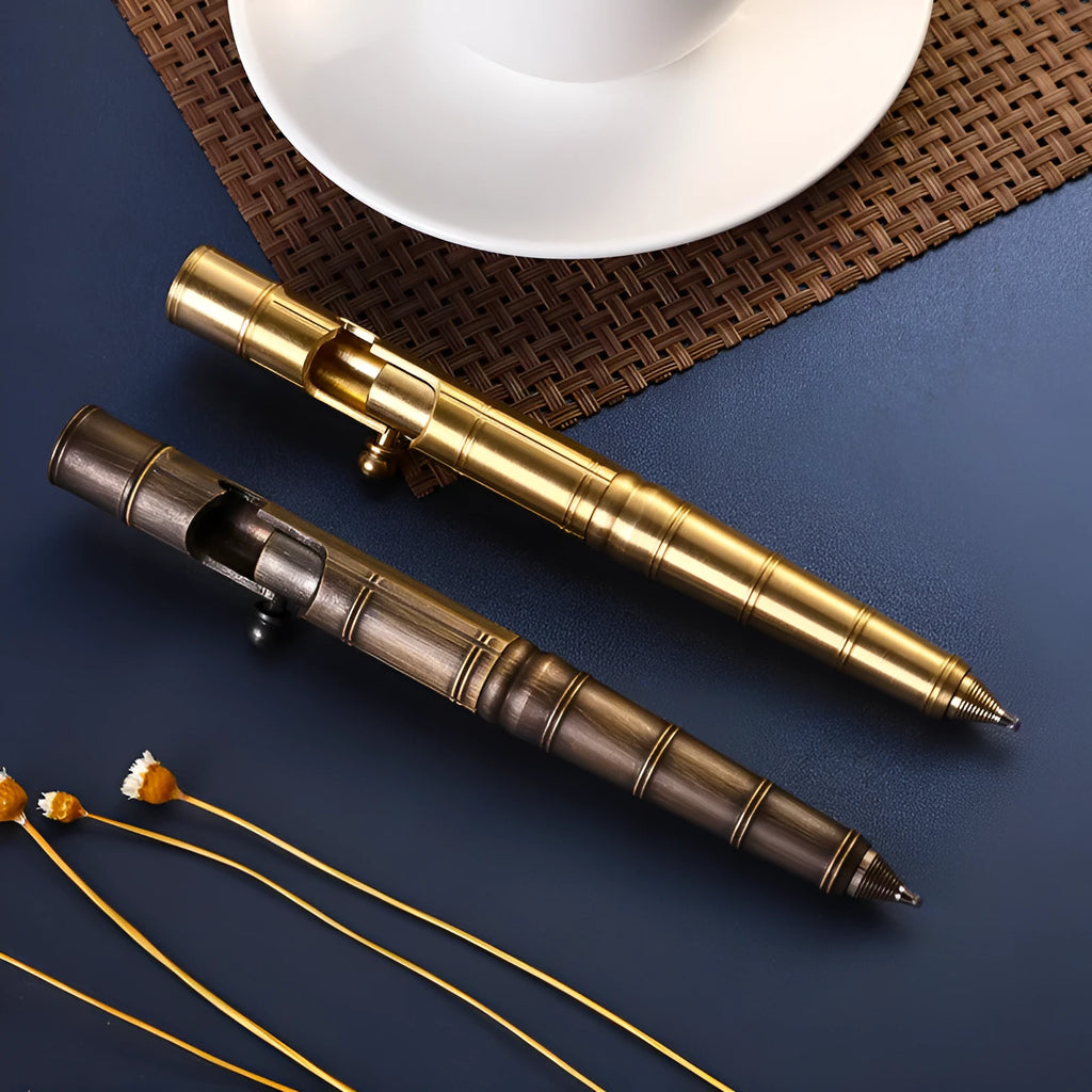 Retro brass bolt-action tactical pen showing press mechanism and solid metal construction.