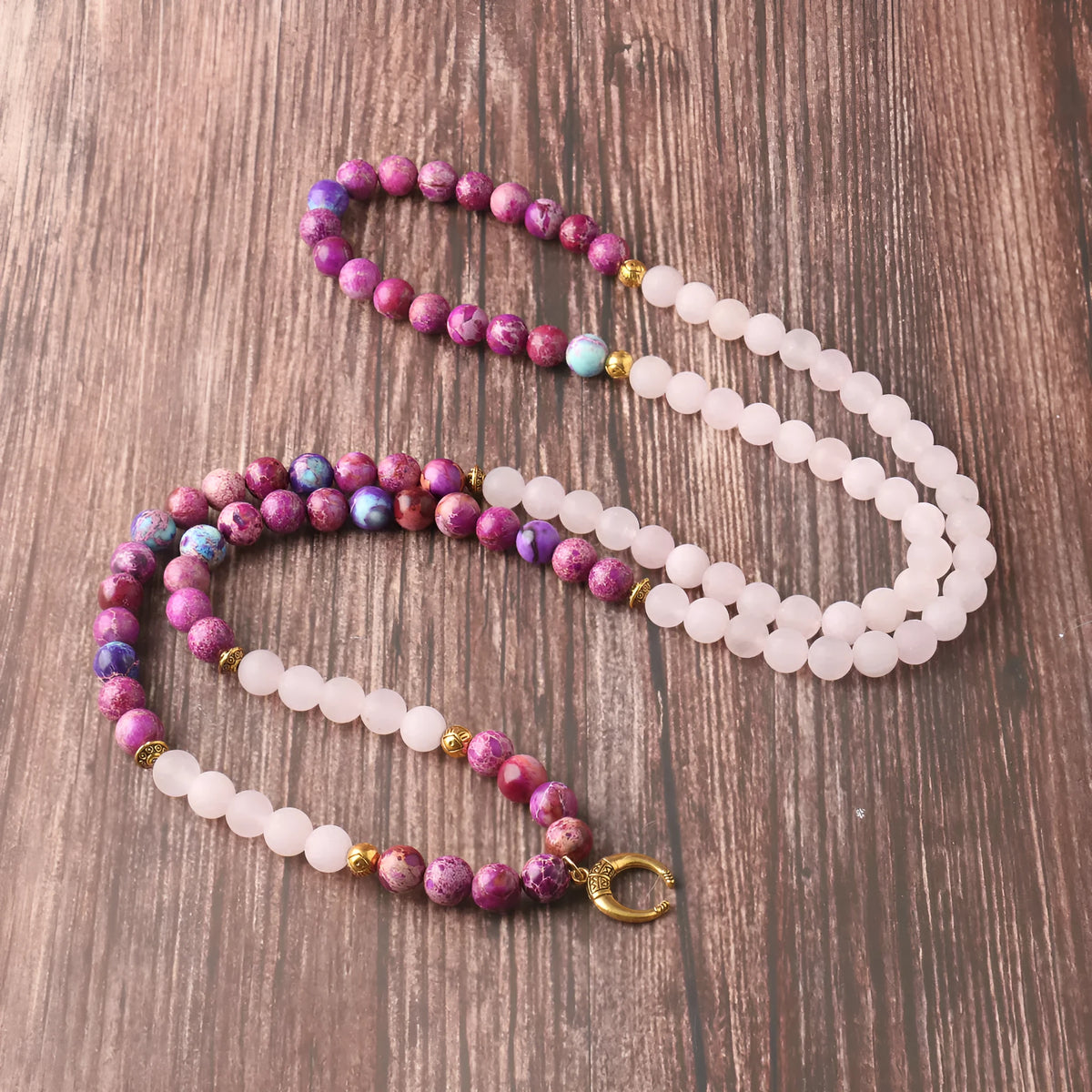 Women's personalised necklace with round Emperor Stone bead pendant showing pink crystal colouration