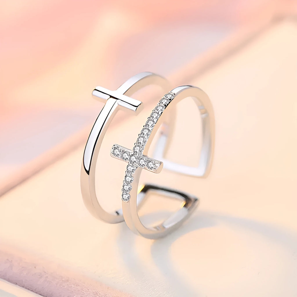Women's adjustable double cross copper ring with zircon stones in sterling silver inlay, shown in a gold electroplated finish.