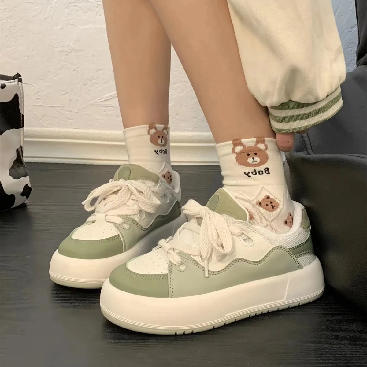Green women's casual shoes with PU mesh upper, flat heel, and round toe on a plain background.