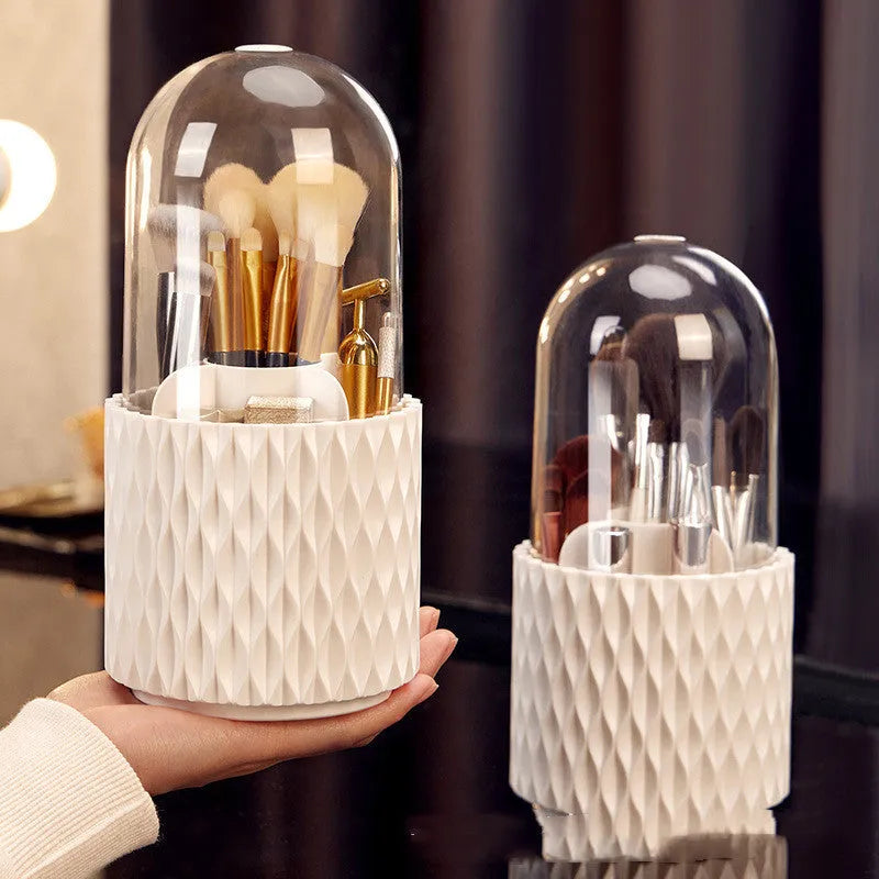 White rotating acrylic makeup brush holder with transparent lid on a desktop