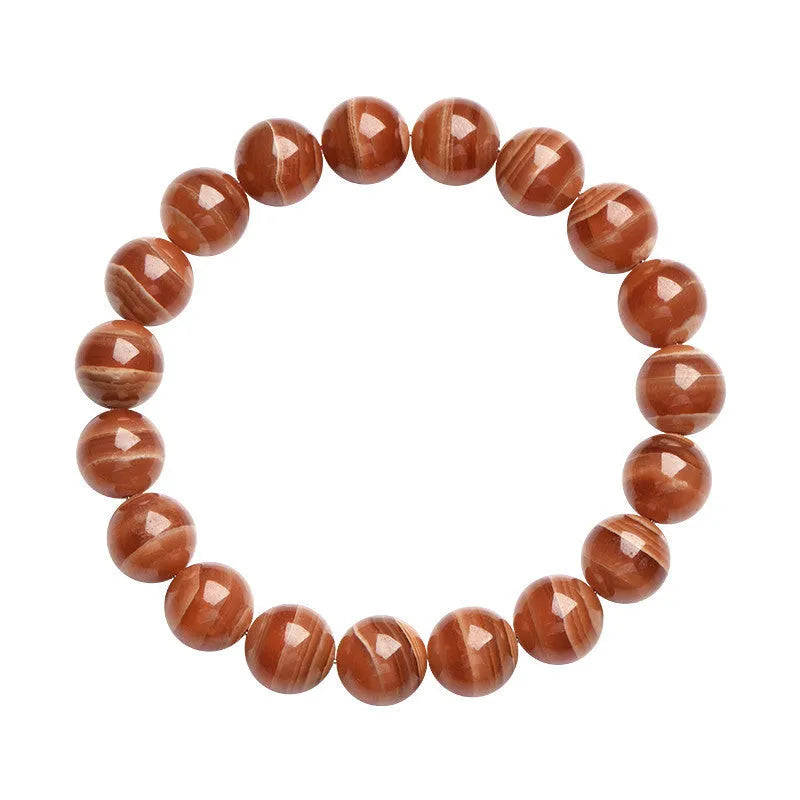 Natural Old Mine Rhodochrosite round bead bracelet with Ruyi design elements on a wrist.