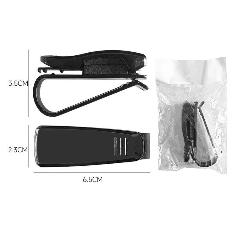 Black plastic car sun visor clip for holding glasses and cards.