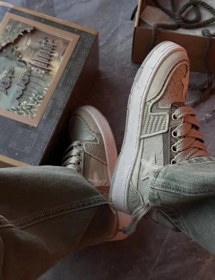 Green low-top casual shoes with star pattern stitching and white rubber sole.