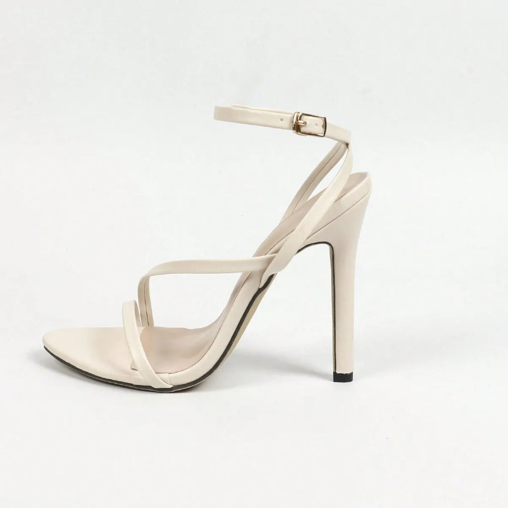 Women's high heels with cross ankle strap in gold, silver, or white with round and open toe.
