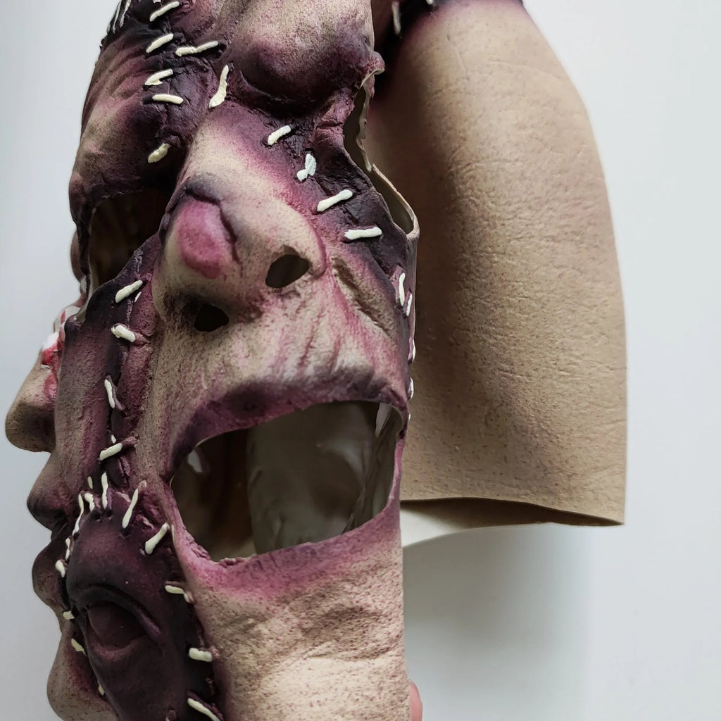 Latex three-sided Grimace horror Halloween mask for adults on a black background.