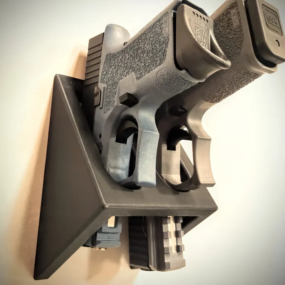 Black punk-style plastic pistol stand for displaying replica guns.