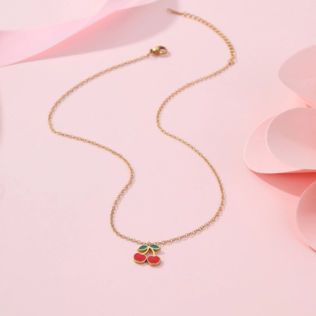 Cherry jewellery set showing necklace, bracelet, earrings, and ring with stainless steel construction and gold plating