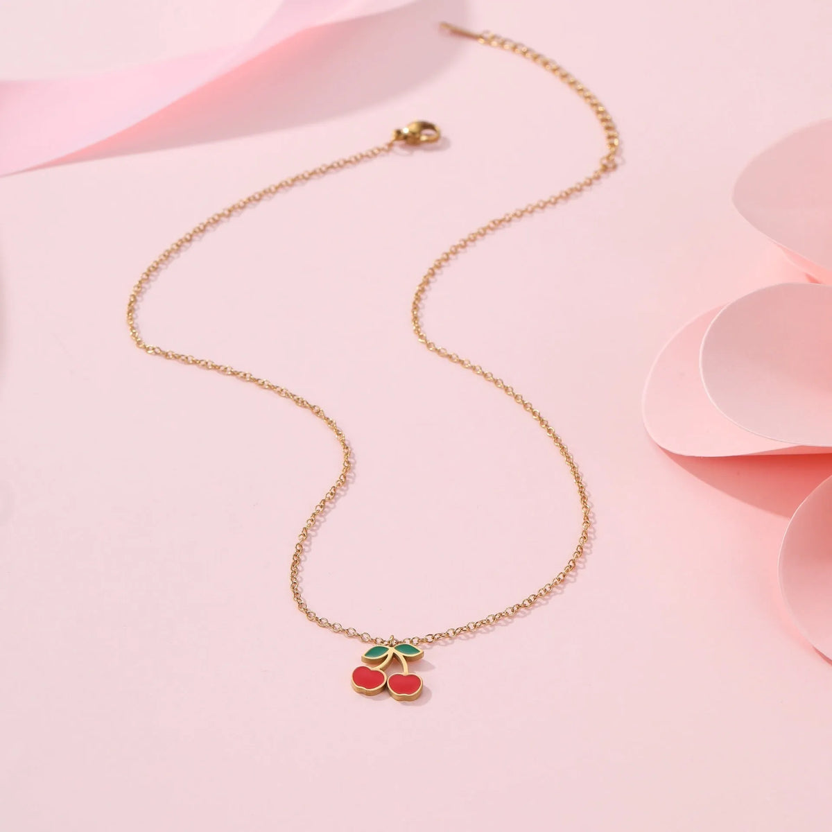 Cherry jewellery set showing necklace, bracelet, earrings, and ring with stainless steel construction and gold plating