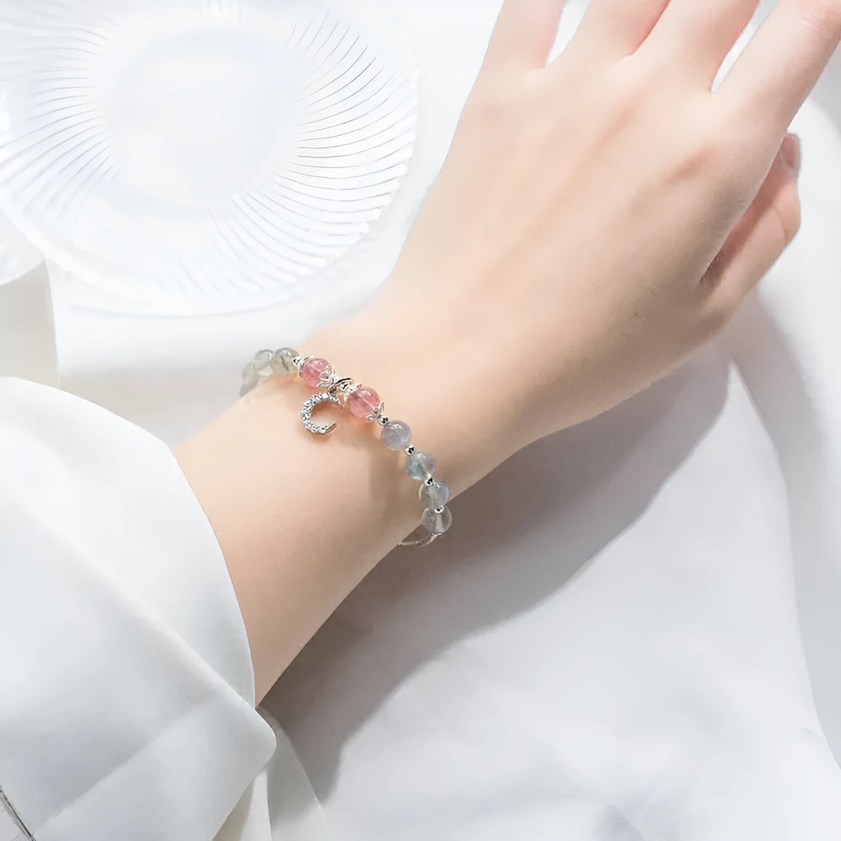 Handmade adjustable silver tone bracelet with natural moonstone crystal and small crescent moon charm