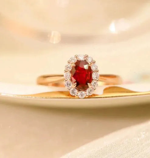 Women's silver-plated floral ring with a gold pigeon red blood gemstone centrepiece.