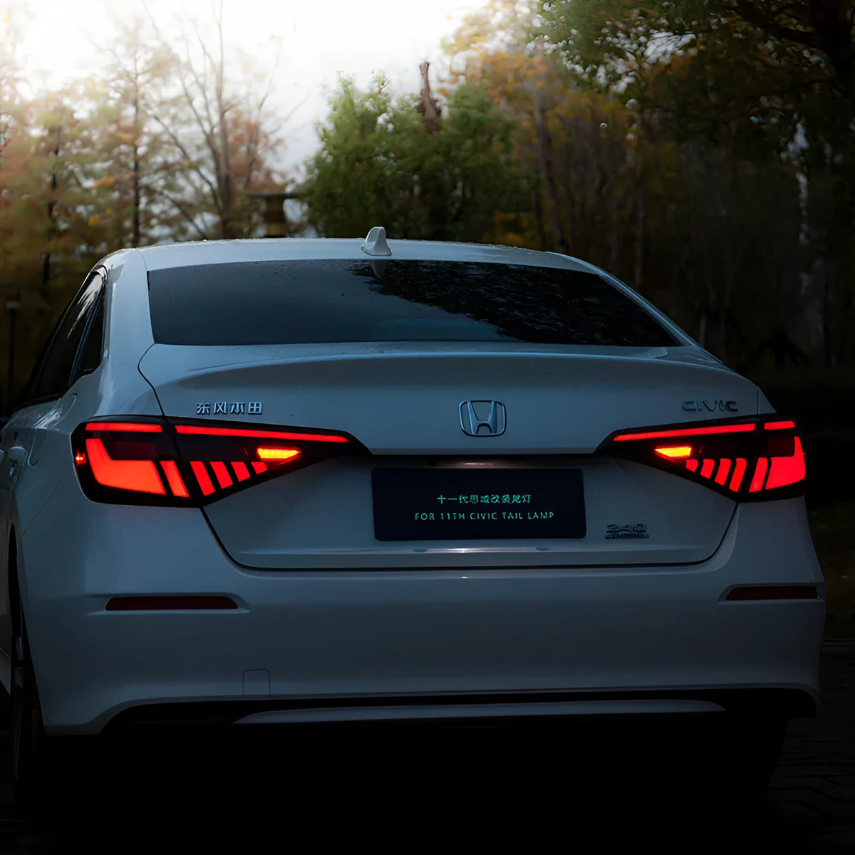 Black and red LED tail light assembly for 11th Generation Honda Civic.