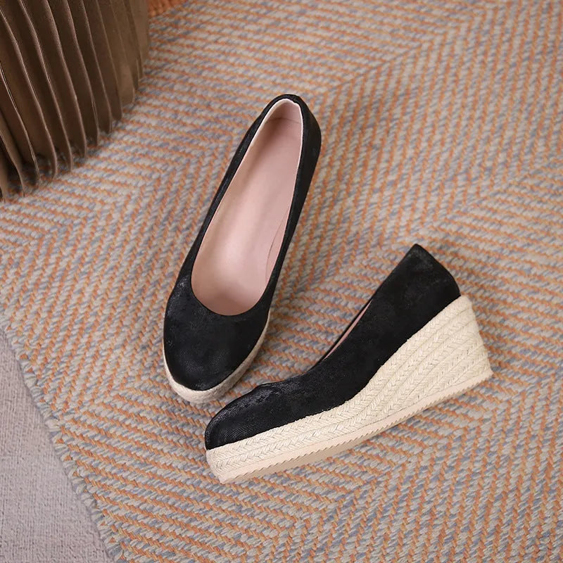 Apricot wedge high heel pumps with round toe and thick platform sole on a neutral background.