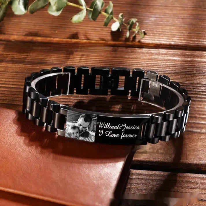 Titanium steel curved heart bracelet with black lettering on wrist