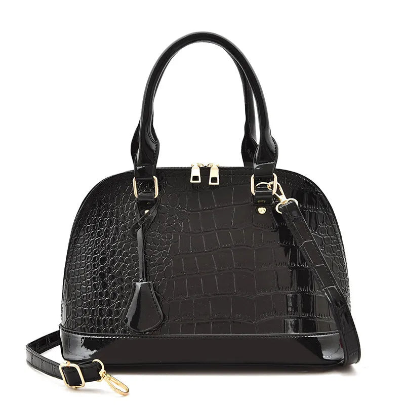 Shiny PU shoulder bag in shell shape showing black, brown, and red colour options