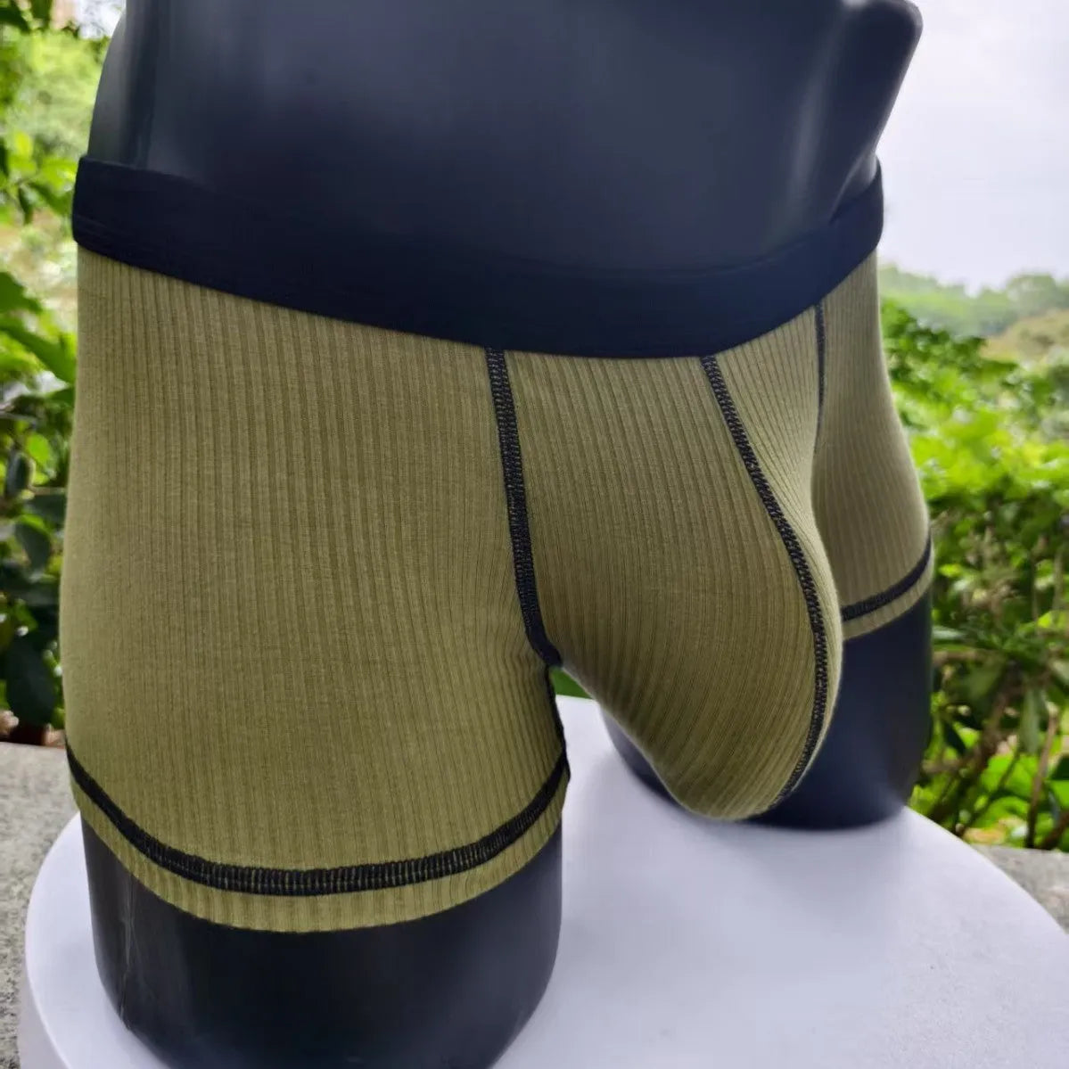 Men's solid colour boxers in Army Green shown flat, highlighting thin breathable fabric and body shaping design.