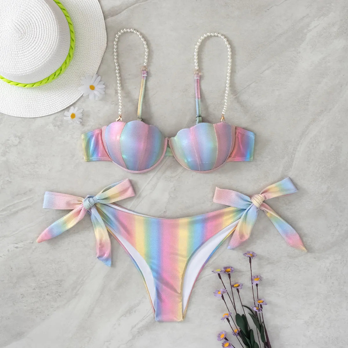 Women's shell rainbow colour split tied bikini swimsuit with triangle top on a neutral background.