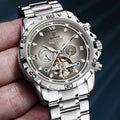 Automatic mechanical watch for men with stainless steel strap on wrist, showing metal case and watch face.