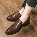 Men's black business casual slip-on shoes with tassel detail and rubber sole