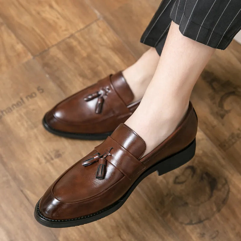 Men's black business casual slip-on shoes with tassel detail and rubber sole