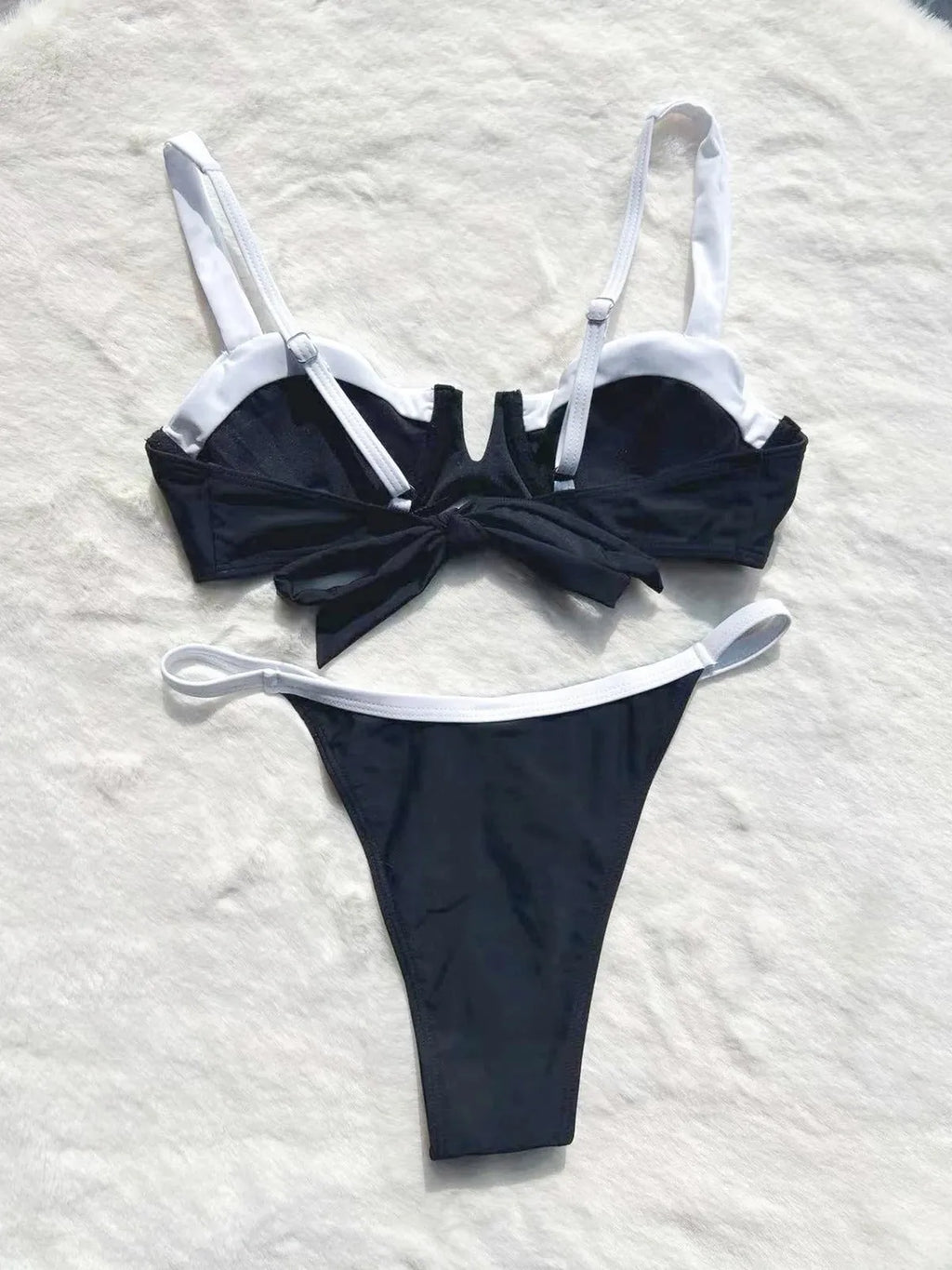 Women's low waist black bikini swimsuit with stitching split detail.