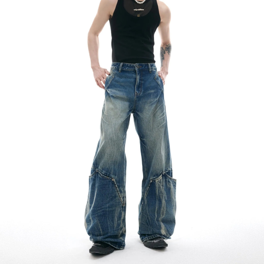 Men's verdant blue loose fit jeans showcasing a retro washed burst pattern and curved knife design details.