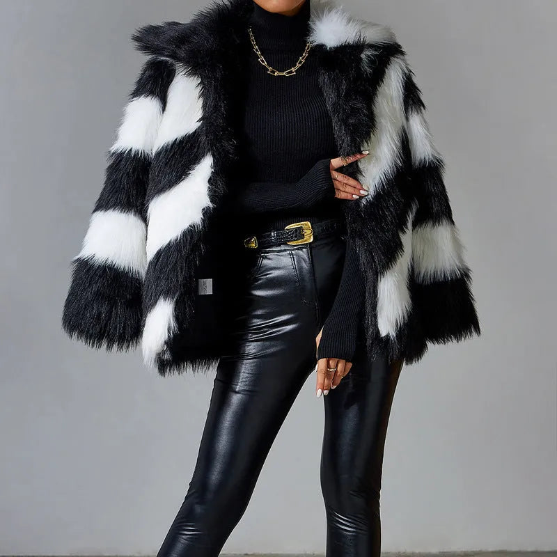 Women's faux fur coat with dark contrast lapels and a light fur collar.