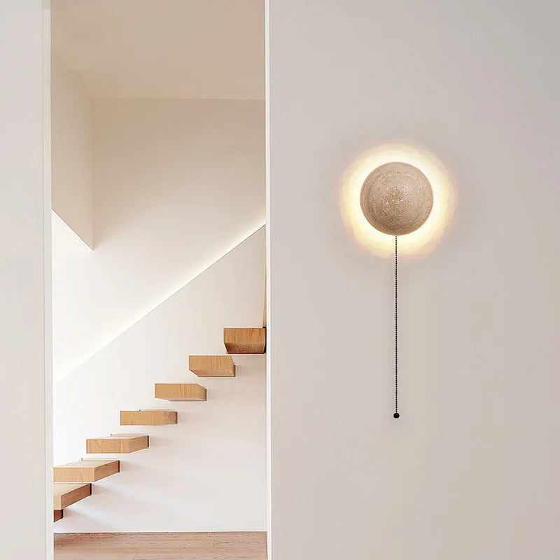 Vintage semicircle wall lamp with a yellow cave stone shade and iron frame, showing pull switch.