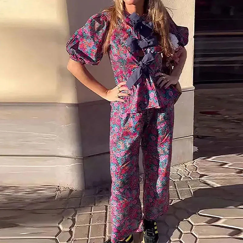 Women's floral print polyester trouser suit with puff sleeves and tie-neck blouse