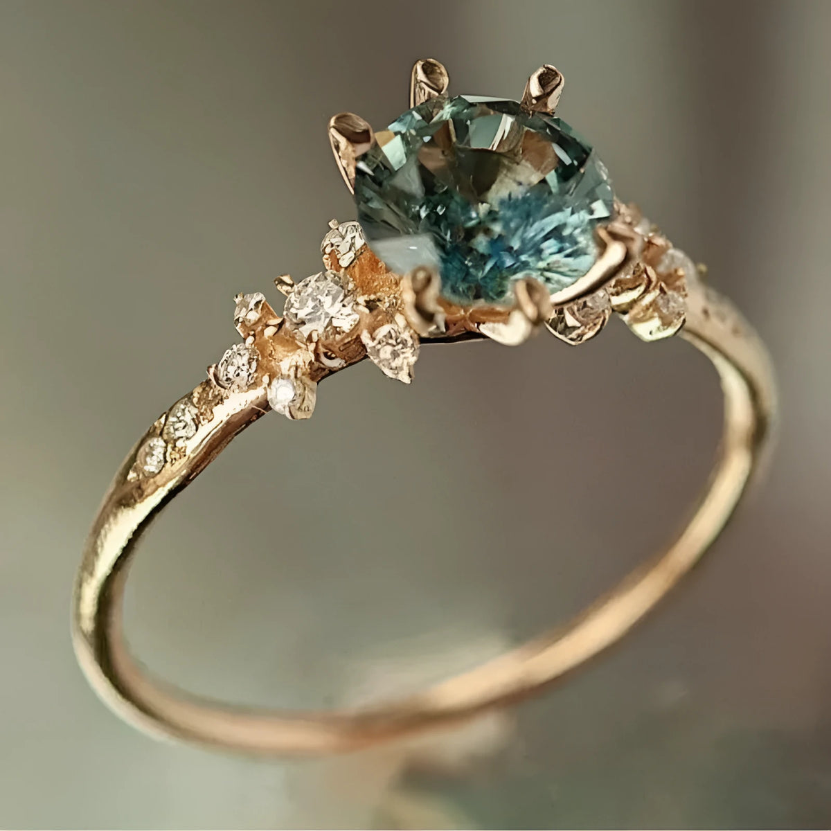 Gold geometric ring with claw-set zircon stones on chamfered square pattern