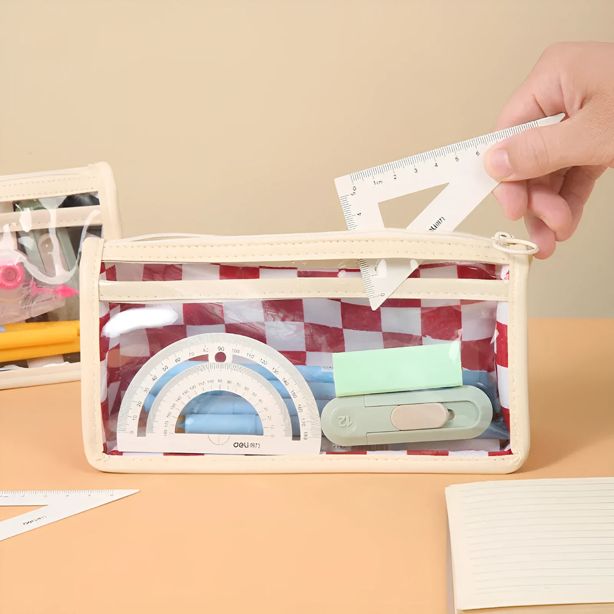 PVC transparent pencil case with chessboard pattern showing pens inside, dimensions 21.5 x 8 x 11.5 cm