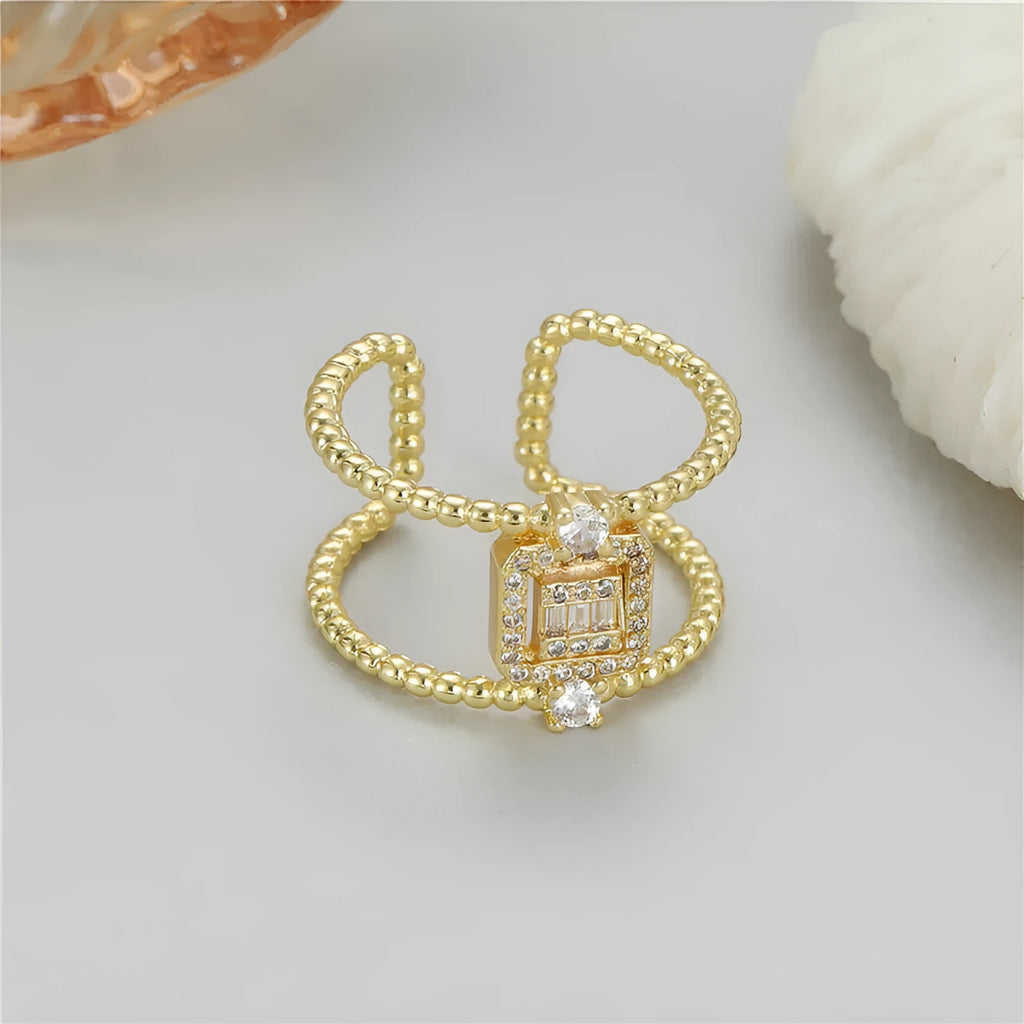 Gold-coloured adjustable open ring with an asymmetric U-shape design.