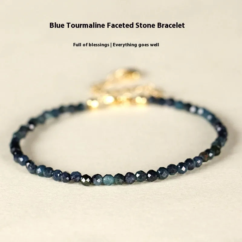 Adjustable blue tourmaline beaded bracelet with spacer beads and gold-colour accents on a wrist.