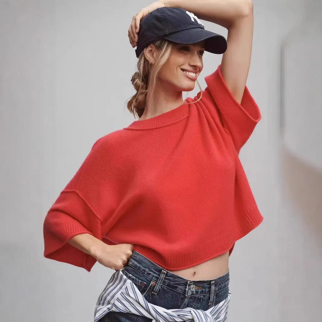 Red cropped viscose t-shirt on a hanger, showing its short length and regular sleeves.
