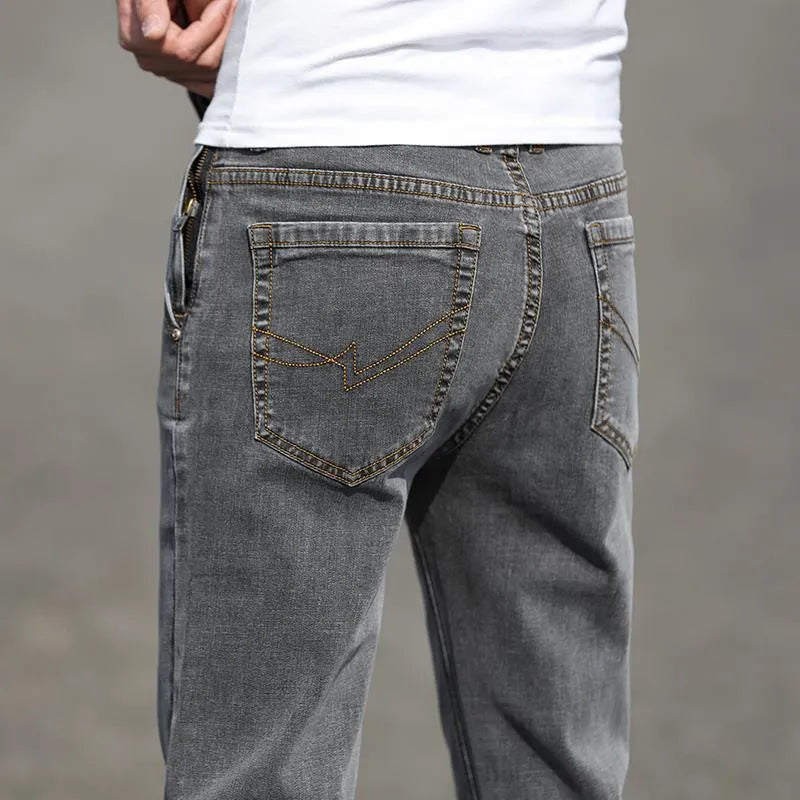 Men's smoky gray straight leg jeans with low waist design and zipper fly closure