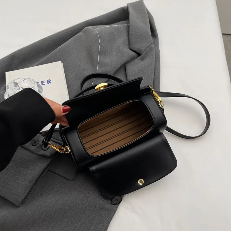 Women's personalised shoulder messenger bag in PU leather with letter detailing and stitching.