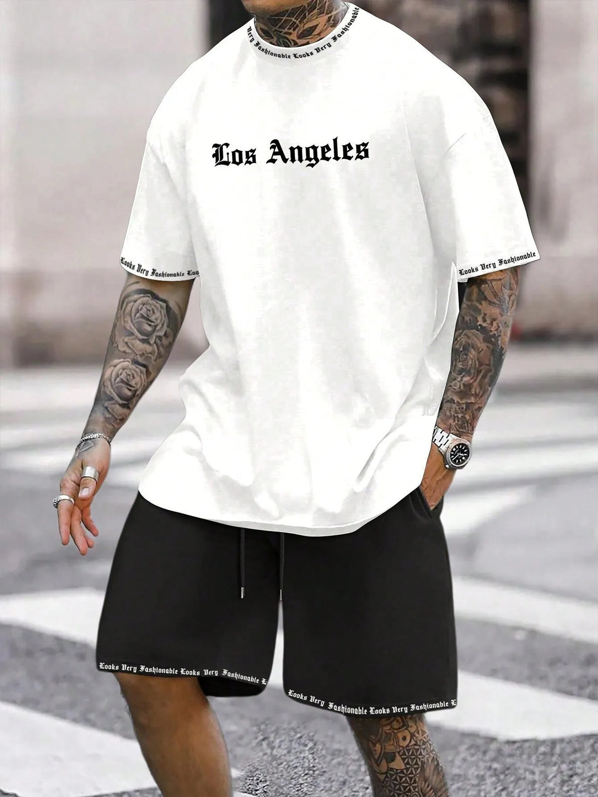 Mens blue sports style short sleeve top and shorts two-piece set on a plain background.