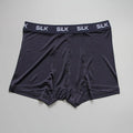Men's loose silk shorts in navy blue, silver gray, and skin color with mid-waist design