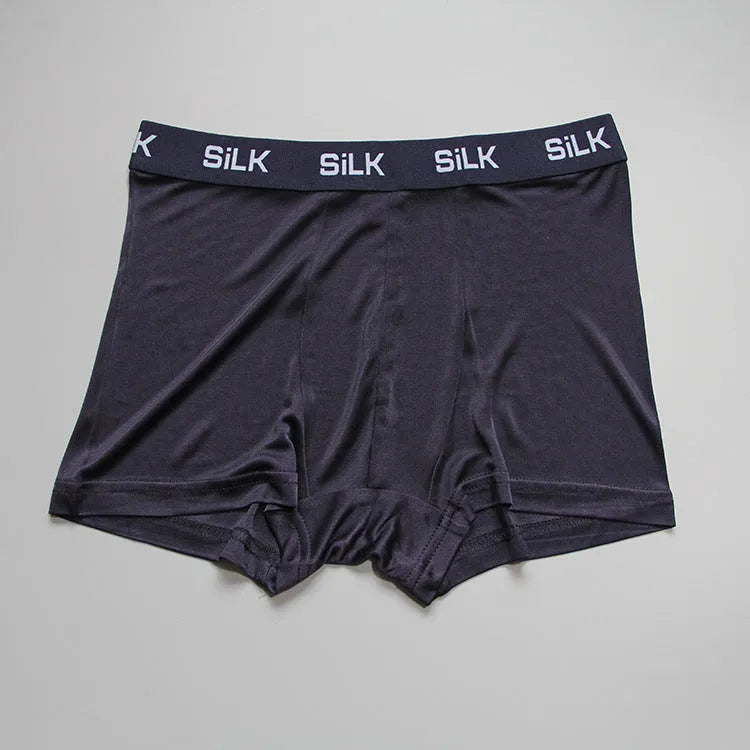 Men's loose silk shorts in navy blue, silver gray, and skin color with mid-waist design