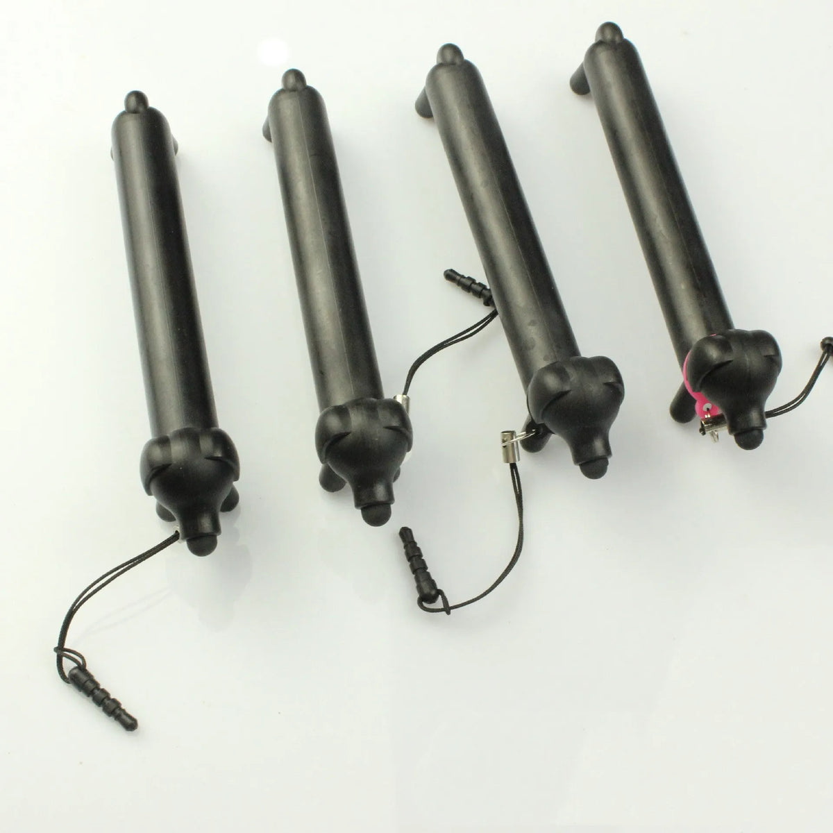 Black dog shaped touch screen stylus showing adjustable length design and phone stand conversion